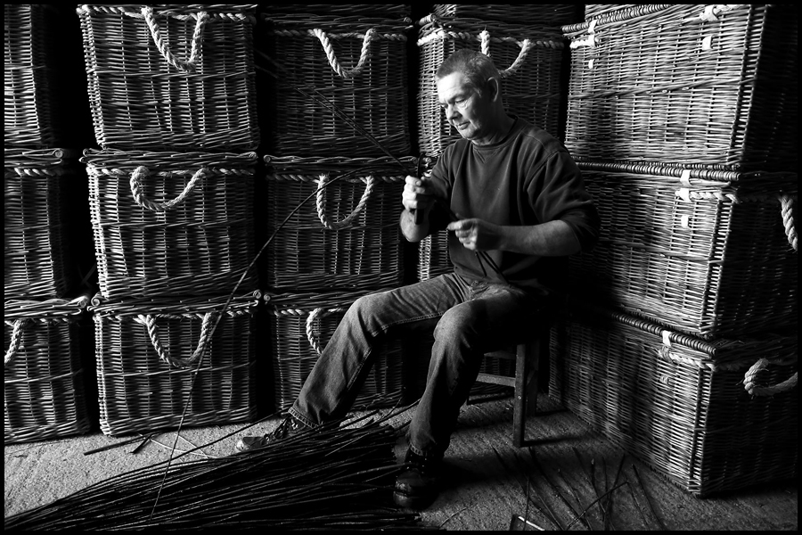 A lone craftsman prepares the willow at Somerset Willow which make the famous Fortnum & Mason luxury hampers.