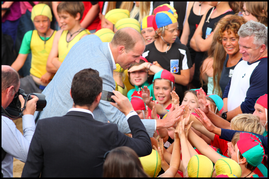 HRH Prince William high fives  members of Newquay Nippers, while visiting a presentation by the Wave Hub charity at Towan Beach in Newquay, Cornwall.