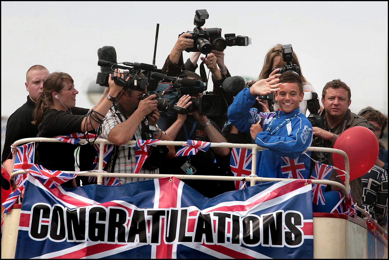 Teenage diving superstar Tom Daley receives a rapturous welcome during his homecoming parade in Plymouth after scooping gold at the World Diving Championships in Rome.