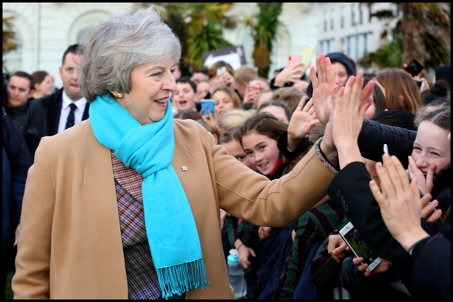 Former Prime Minister Theresa May MP, high fives schoolchildren after unveiling a statue to Nancy Astor on Plymouth Hoe.