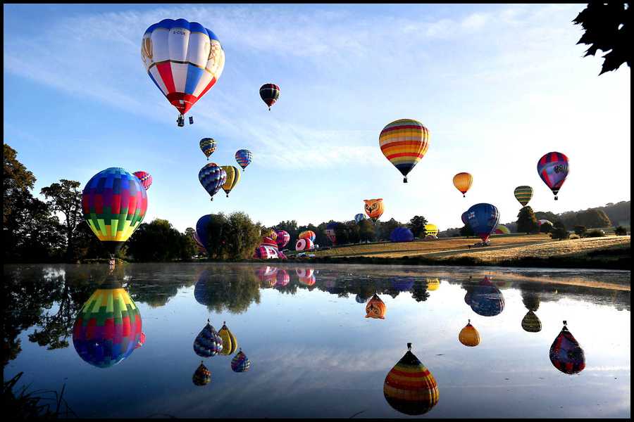 The skies over Longleat are awash with colourful hot air balloons in the Saturday morning Mass Balloon Launch during the 2019 Sky Safari. Picture published in The Observer newspaper.