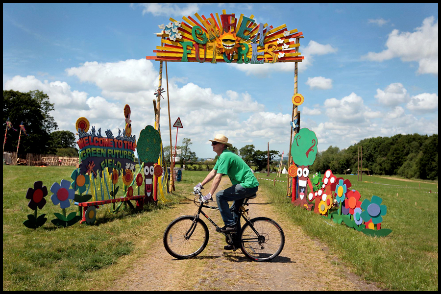 A lone cyclist rides past the Green Fields site brfore the start of the 2009 Glastonbury Festival.