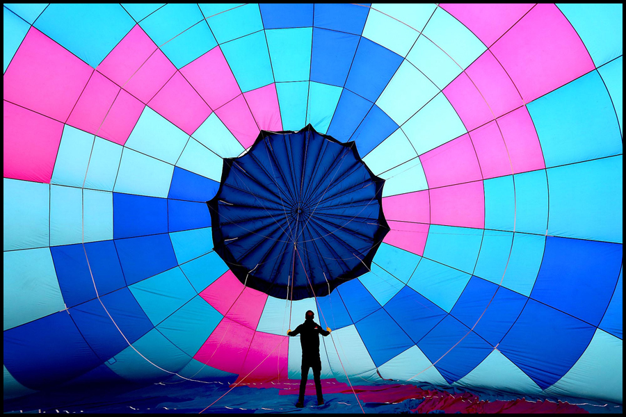 The skies over Longleat are awash with colourful hot air balloons in the Saturday morning Mass Balloon Launch during the 2019 Sky Safari. Picture published in The Telegraph newspaper.