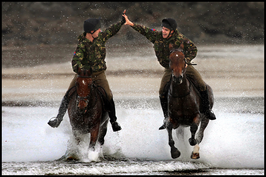 Horses and riders from the Royal Horse Artillary enjoy their summer holiday at Polzeath, Cornwall. Published by The Western Morning News