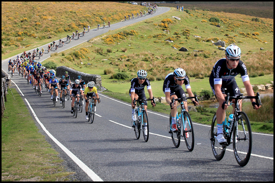 The Tour of Britain bike race pictured against the dramatic landscape of Dartmoor National Park in Devon.